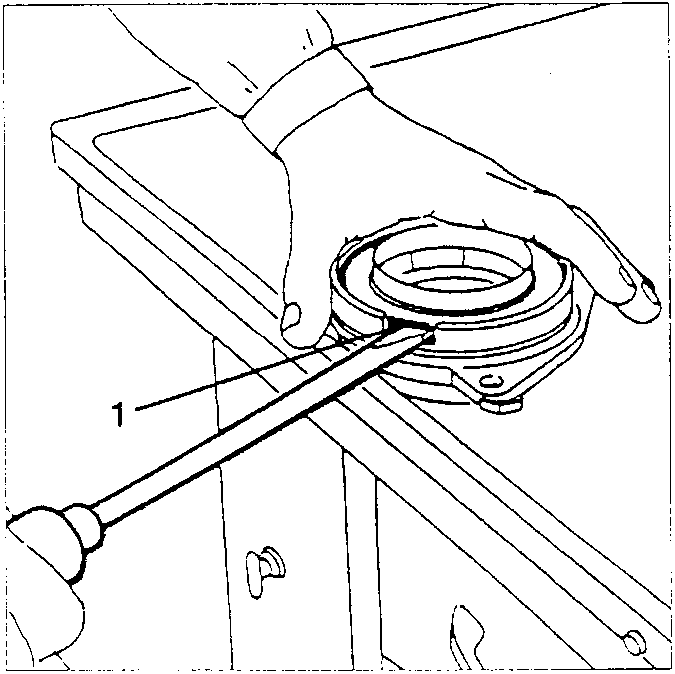 Hand using screwdriver to remove oil seal from differential box